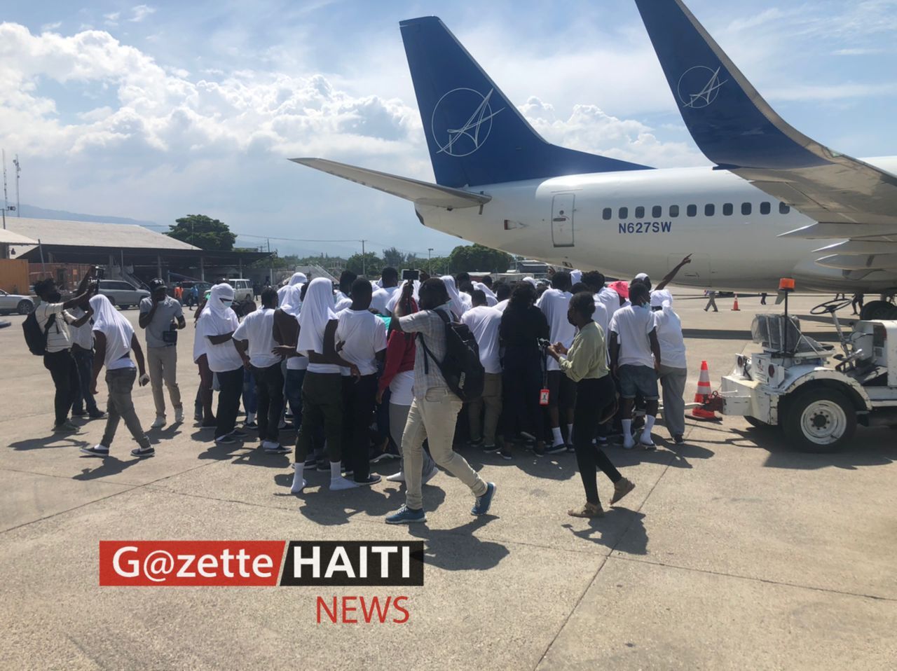 Des migrants haïtiens sur le tarmac de l'aéroport